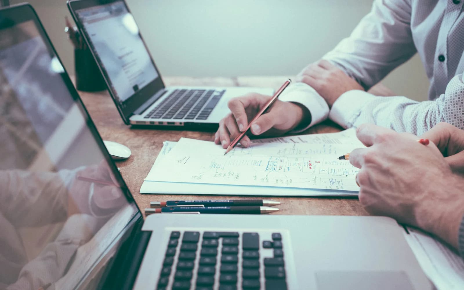 Financial professionals reviewing documents at a desk