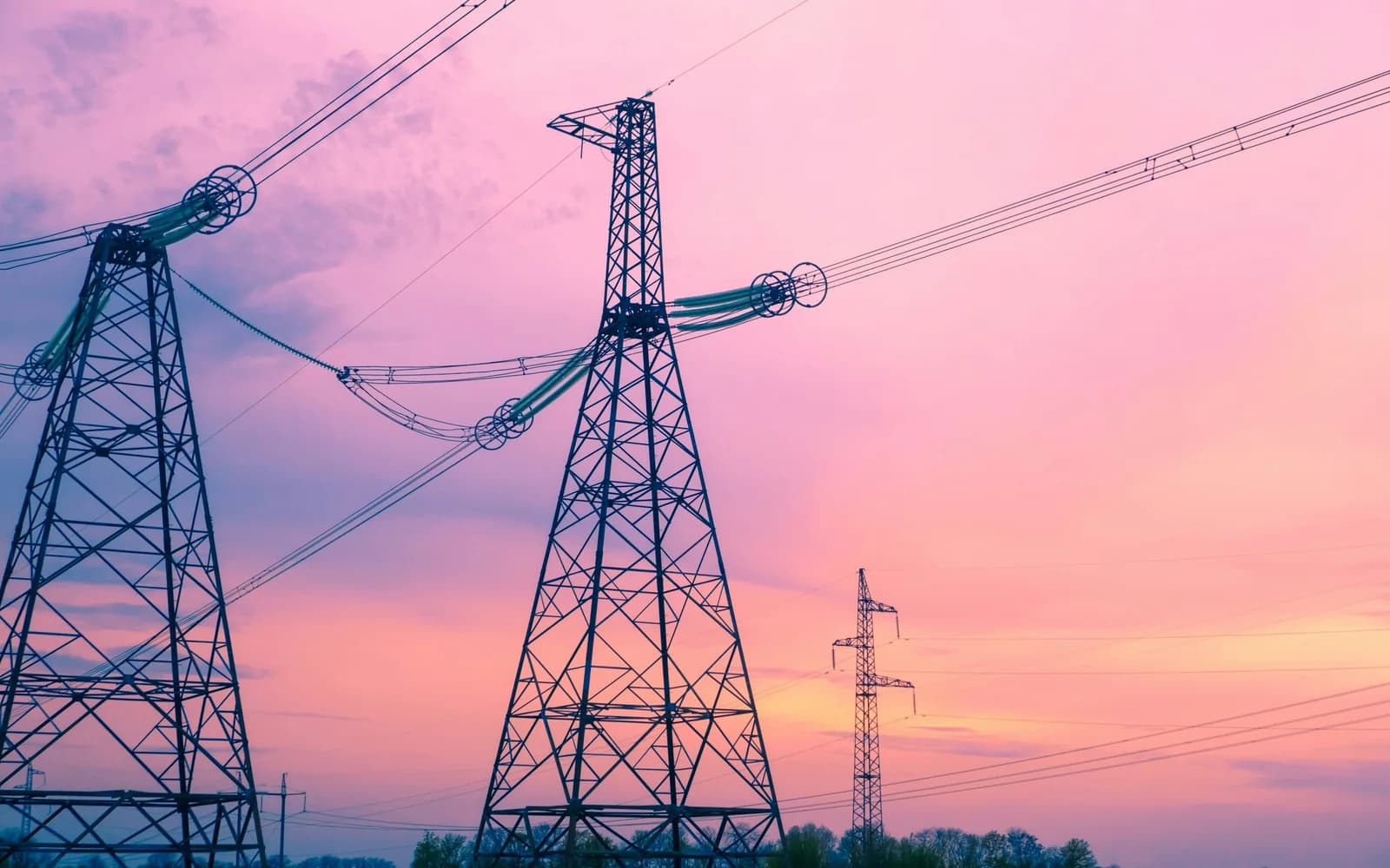 High-voltage transmission towers at sunset